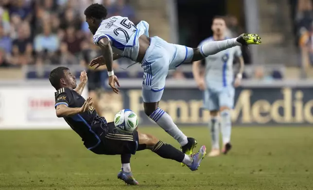 Philadelphia Union's Kai Wagner, left, and CF Montréal's Dante Sealy collide during the first half of an MLS soccer match, Wednesday, July 16, 2025, in Chester, Pa. (AP Photo/Matt Slocum)