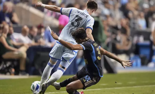 Philadelphia Union's Quinn Sullivan, right, clears the ball from CF Montréal's Tom Pearce during the second half of an MLS soccer match, Wednesday, July 16, 2025, in Chester, Pa. (AP Photo/Matt Slocum)