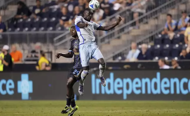 CF Montréal's Prince Osei Owusu, right, leaps for the ball past Philadelphia Union's Olwethu Makhanya during the second half of an MLS soccer match, Wednesday, July 16, 2025, in Chester, Pa. (AP Photo/Matt Slocum)