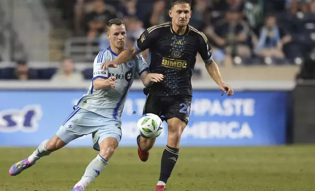 CF Montréal's Fabian Herbers, left, and Philadelphia Union's Bruno Damiani battle for the ball during the first half of an MLS soccer match, Wednesday, July 16, 2025, in Chester, Pa. (AP Photo/Matt Slocum)