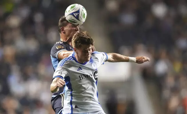 Philadelphia Union's Frankie Westfield, left, and CF Montréal's Tom Pearce leap for the ball during the second half of an MLS soccer match, Wednesday, July 16, 2025, in Chester, Pa. (AP Photo/Matt Slocum)