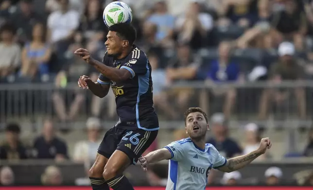 Philadelphia Union's Nathan Harriel, left, leaps for the ball past CF Montréal's Luca Petrasso during the first half of an MLS soccer match, Wednesday, July 16, 2025, in Chester, Pa. (AP Photo/Matt Slocum)
