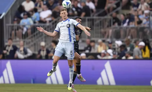 CORRECTS TEAM NAME TO CF MONTREAL NOT TORONTO FC AND CORRECTS MONTREAL PLAYER'S NAME - CF Montreal's Brandan Craig, left, and Philadelphia Union's Tai Baribo leap for the ball during the first half of an MLS soccer match, Wednesday, July 16, 2025, in Chester, Pa. (AP Photo/Matt Slocum)