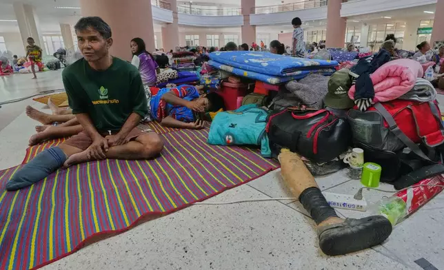 Thai residents who fled homes following the clashes between Thai and Cambodian soldiers, rest at an evacuation center in Surin province, Thailand, Wednesday, July 30, 2025. (AP Photo/Sakchai Lalit)