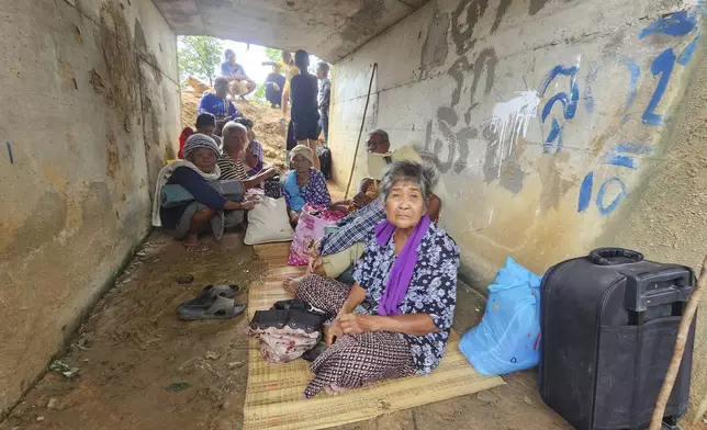 Thai people who fled clashes between Thai and Cambodian soldiers take shelter in Surin province, northeastern Thailand, Thursday, July 24, 2025. (AP Photo/Sunny Chittawil)