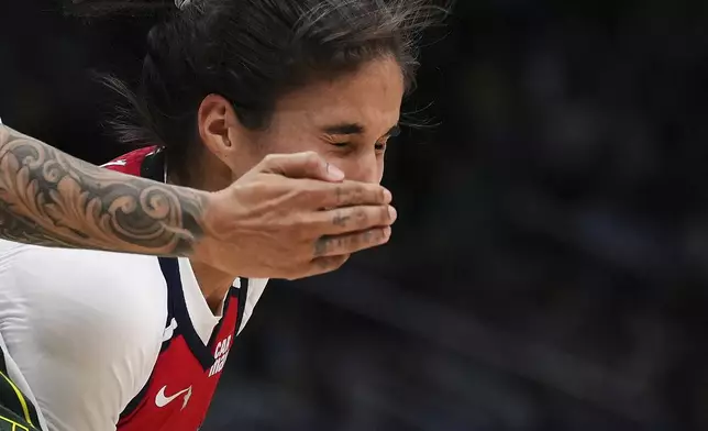 Washington Mystics guard Sonia Citron is fouled by Seattle Storm forward Gabby Williams, left, while going to the basket during the second half of a WNBA basketball game Sunday, July 13, 2025, in Seattle. (AP Photo/Lindsey Wasson)
