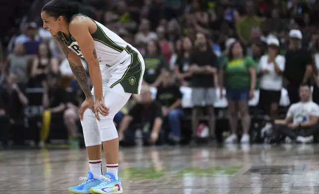 Seattle Storm forward Gabby Williams hunches over before limping off the court late during the second half of a WNBA basketball game against the Washington Mystics, Sunday, July 13, 2025, in Seattle. (AP Photo/Lindsey Wasson)