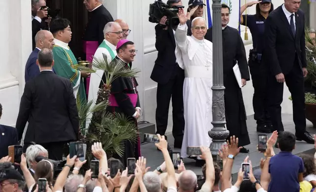 Pope Leo XIV waves to faithful as he arrives to celebrate a mass inside the St. Thomas of Villanova church in Castel Gandolfo, Sunday, July 13, 2025. (AP Photo/Gregorio Borgia)