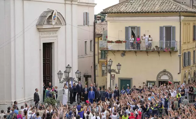 Pope Leo XIV waves to faithful as he arrives to celebrate a mass inside the St. Thomas of Villanova church in Castel Gandolfo, Sunday, July 13, 2025. (AP Photo/Gregorio Borgia)