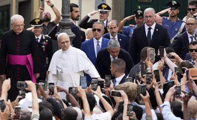 Pope Leo XIV waves to faithful as he arrives to celebrate a mass inside the St. Thomas of Villanova church in Castel Gandolfo, Sunday, July 13, 2025. (AP Photo/Gregorio Borgia)
