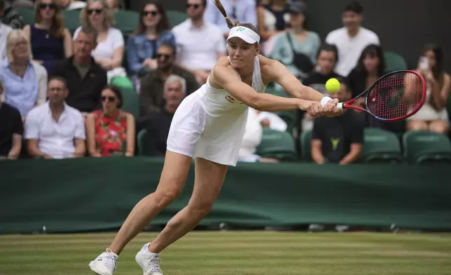 Elena Rybakina of Kazakhstan plays a return to Clara Tauson of Denmark during their women's singles third round match at the Wimbledon Tennis Championships in London, Saturday, July 5, 2025.(AP Photo/Kin Cheung)
