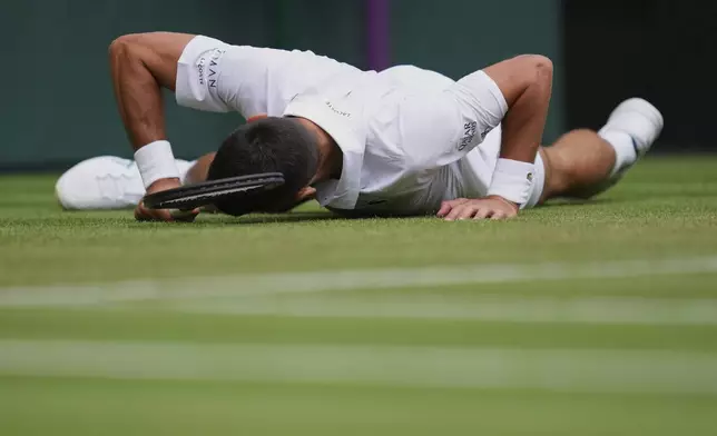 Novak Djokovic of Serbia slips and fall as he plays Miomir Kecmanovic of Serbia during a third round men's singles match at the Wimbledon Tennis Championships in London, Saturday, July 5, 2025. (AP Photo/Kirsty Wigglesworth)