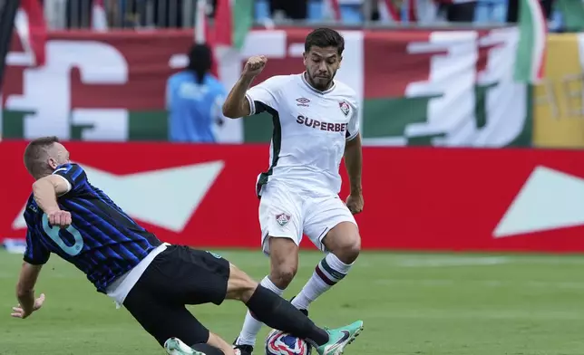 Inter Milan's Stefan de Vrij, left, and Fluminense's Nonato challenge for the ball during the Club World Cup round of 16 soccer match between Inter Milan and Fluminense in Charlotte, N.C., Monday, June 30, 2025. (AP Photo/Chris Carlson)