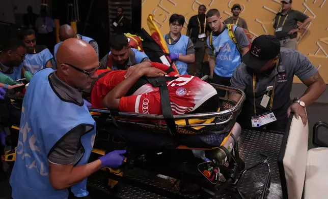 Bayern Munich's Jamal Musiala is taken off the field after an injury during the Club World Cup quarterfinal soccer match between PSG and Bayern Munich in Atlanta, Saturday, July 5, 2025. (AP Photo/Brynn Anderson)