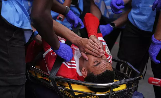 Bayern Munich's Jamal Musiala is taken off the field after an injury during the Club World Cup quarterfinal soccer match between PSG and Bayern Munich in Atlanta, Saturday, July 5, 2025. (AP Photo/Brynn Anderson)