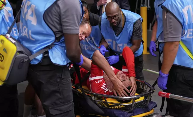 Bayern Munich's Jamal Musiala is taken off the field after an injury during the Club World Cup quarterfinal soccer match between PSG and Bayern Munich in Atlanta, Saturday, July 5, 2025. (AP Photo/Brynn Anderson)