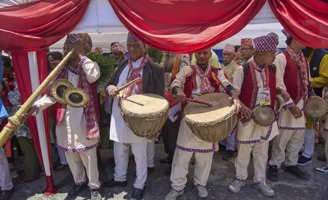 Pro-monarchy supporters play traditional music as they line up to offer birthday wishes to former King Gyanendra Shah at his residence, in Kathmandu, Nepal, Monday, July 7, 2025. (AP Photo/Niranjan Shrestha)