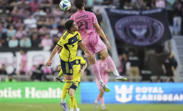 Inter Miami's Tadeo Allende (21) heads there ball as Nashville SC defender Daniel Lovitz, left, defends during the first half of an MLS soccer match, Saturday, July 12, 2025, in Fort Lauderdale, Fla. (AP Photo/Lynne Sladky)