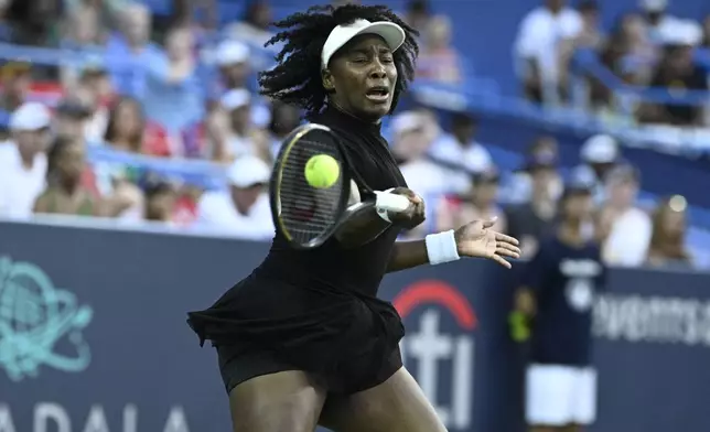 Venus Williams returns the ball against Magdalena Frech, of Poland, during a match at the Citi Open tennis tournament Thursday, July 24, 2025, in Washington. (AP Photo/Nick Wass)