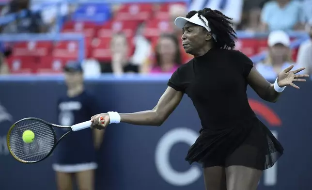 Venus Williams returns the ball against Magdalena Frech, of Poland, during a match at the Citi Open tennis tournament Thursday, July 24, 2025, in Washington. (AP Photo/Nick Wass)