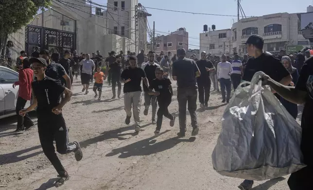 Palestinians gather their belongings ahead of homes demolition by Israeli forces in the Tulkarem refugee camp, West Bank, Wednesday, July 2, 2025. (AP Photo/Majdi Mohammed)