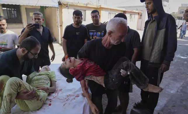 EDS NOTE: GRAPHIC CONTENT - The bodies of two Palestinian sisters Sabah and Mira Bashir who were killed in an Israeli army airstrike of the Gaza Strip are brought to Al-Aqsa Hospital in Deir al-Balah, Wednesday, July 2, 2025. (AP Photo/Abdel Kareem Hana)
