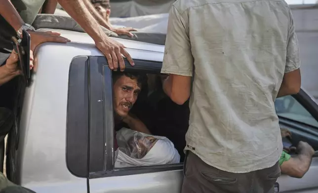 Palestinians carry the body of a relative of Dr. Marwan Sultan, director of the Indonesian Hospital in northern Gaza, who was killed along with him in an Israeli airstrike, at Shifa Hospital in Gaza City on Wednesday, July 2, 2025. (AP Photo/Jehad Alshrafi)