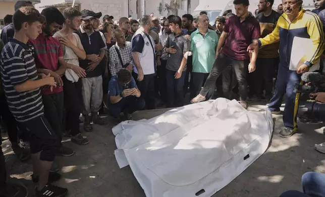 Palestinians gather around the bodies of Dr. Marwan Sultan the director of the Indonesian Hospital in the northern Gaza Strip, his wife, daughter, and son in law, after they were killed in an Israeli airstrike, at Shifa Hospital in Gaza City Wednesday, July 2, 2025. (AP Photo/Jehad Alshrafi)