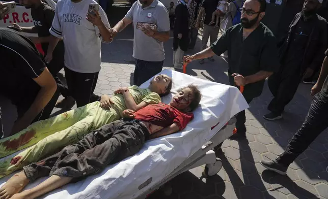 EDS NOTE: GRAPHIC CONTENT - The bodies of two Palestinian sisters Sabah and Mira Bashir who were killed in an Israeli army airstrike of the Gaza Strip are brought to Al-Aqsa Hospital in Deir al-Balah, Wednesday, July 2, 2025. (AP Photo/Abdel Kareem Hana)