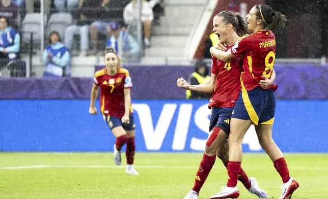 Spain's Irene Paredes, left, and Spain's Esther Gonzalez celebrate their side's second goal of the game during the UEFA Women's EURO 2025 Group B soccer match between Spain and Belgium at the Stockhorn Arena in Thun, Switzerland, Monday, July 7, 2025. (Til Buergy/Keystone via AP)