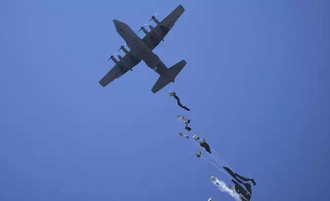 Humanitarian aid is airdropped to Palestinians over Zawaida, central Gaza Strip Thursday, July 31, 2025. (AP Photo/Abdel Kareem Hana)