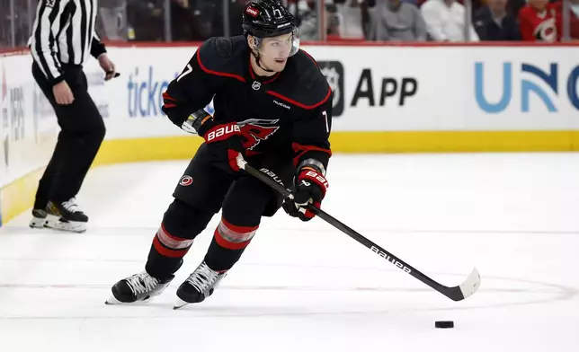 FILE - Carolina Hurricanes' Dmitry Orlov (7) controls the puck against the New Jersey Devils during the second period of Game 2 of an NHL hockey Stanley Cup first-round playoff series in Raleigh, N.C., Tuesday, April 22, 2025. (AP Photo/Karl DeBlaker, File)