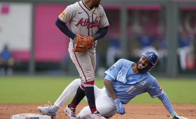 Kansas City Royals' Maikel Garcia (11) is forced out at second by Atlanta Braves second baseman Ozzie Albies as he tried to advance on a force out hit into by Bobby Witt Jr. during the third inning of a baseball game Wednesday, July 30, 2025, in Kansas City, Mo. (AP Photo/Charlie Riedel)