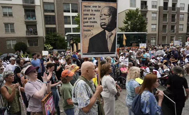 People take part in the annual Rep. John Lewis Way March, honoring the late congressman and civil rights leader, in Nashville, Tenn., Saturday, July 19, 2025. (AP Photo/George Walker IV)