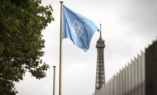 The UNESCO flag flies at its headquarters Tuesday, July 22, 2025 in Paris. (AP Photo/Thomas Padilla)