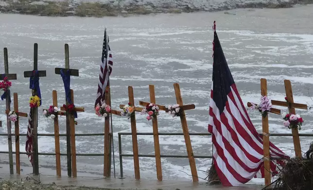 FILE - Rain falls over a makeshift memorial for flood victims along the Guadalupe River, Sunday, July 13, 2025, in Kerrville, Texas. (AP Photo/Eric Gay, File)