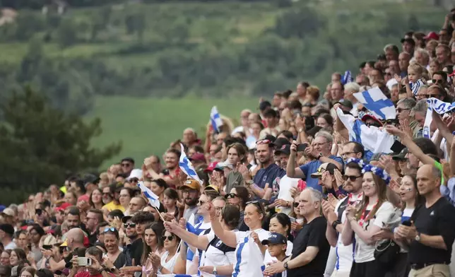 Finland fans stand during the national anthem before the Euro 2025, group A, soccer match between Norway and Finland at Stade de Tourbillon in Sion, Switzerland, Sunday, July 6, 2025. (AP Photo/Alessandra Tarantino)