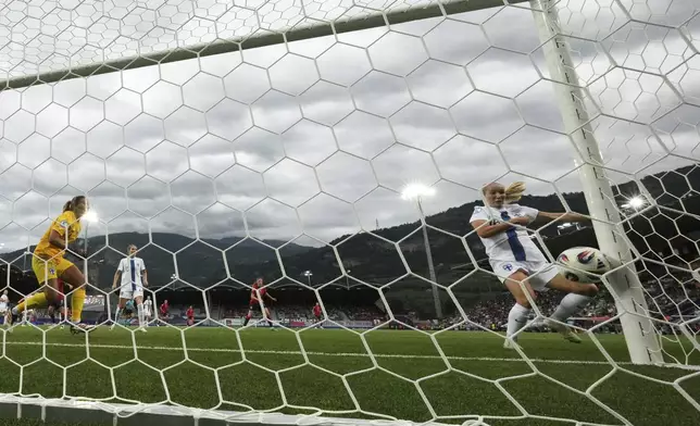 Finland goalkeeper Anna Koivunen, at left, and teammate Nea Lehtola, at right, fail to stop a goal from Norway's Caroline Graham during the Euro 2025, group A, soccer match between Norway and Finland at Stade de Tourbillon in Sion, Switzerland, Sunday, July 6, 2025. (AP Photo/Alessandra Tarantino)