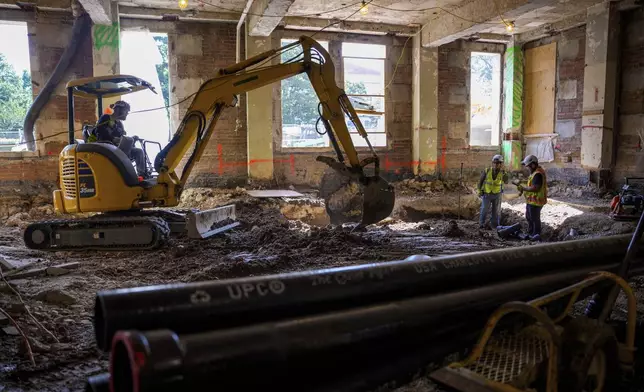 An excavator works on the ground floor of the 1951 Constitution Avenue Building as renovations continue on the Federal Reserve, Thursday, July 24, 2025, in Washington. (Andrew Harnik/Pool Photo via AP)