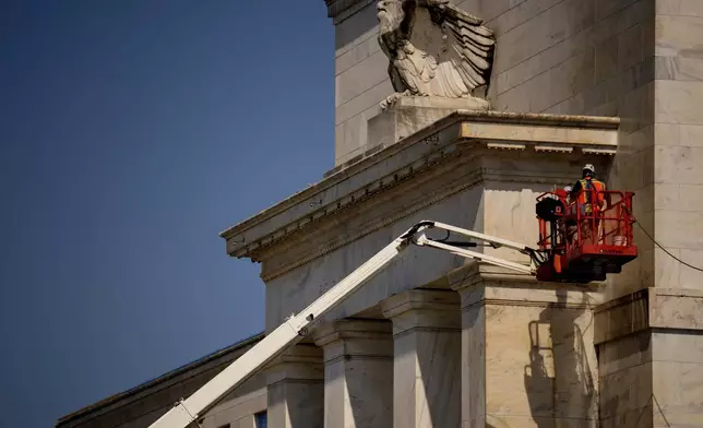 The front facade of the Marriner S. Eccles Federal Reserve Board Building is visible as renovations continue on the Federal Reserve, Thursday, July 24, 2025, in Washington. (Andrew Harnik/Pool Photo via AP)