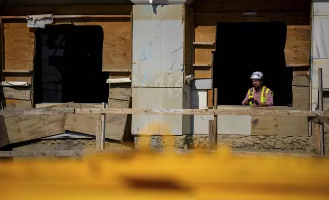 A worker is seen in the Marriner S. Eccles Federal Reserve Board Building as renovations continue on the Federal Reserve, Thursday, July 24, 2025, in Washington. (Andrew Harnik/Pool Photo via AP)
