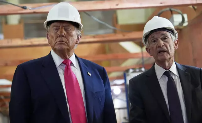 President Donald Trump listens as Federal Reserve Chairman Jerome Powell speaks during a visit to the Federal Reserve, Thursday, July 24, 2025, in Washington. (AP Photo/Julia Demaree Nikhinson)