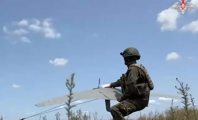 In this photo taken from video distributed by Russian Defense Ministry Press Service on Thursday, July 17, 2025, a Russian serviceman operates a "Supercam" drone in an undisclosed location in Ukraine. (Russian Defense Ministry Press Service via AP)