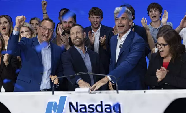 Jeffrey Housenbold, CEO and president of MrBeast, center, participates in a closing bell ceremony with MrBeast's "Beast Games" winner Jeffrey Allen, right, and Joe Brantuk, Nasdaq chief client officer, left, at their studio Wednesday, July 23, 2025, in New York's Times Square. (AP Photo/Stefan Jeremiah)