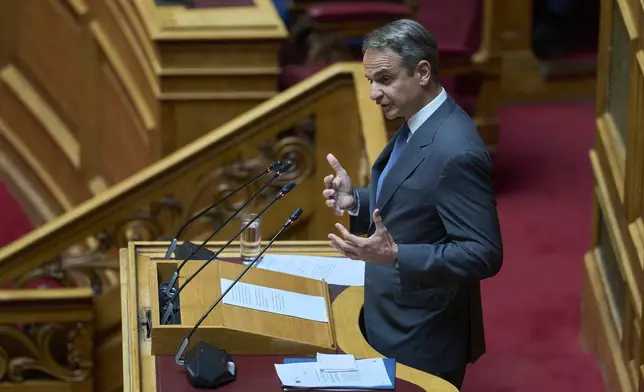 Greek Prime Minister Kyriakos Mitsotakis speaks during a parliamentary session on migration policy in Athens, Wednesday, July 9, 2025. (AP Photo/Petros Giannakouris)