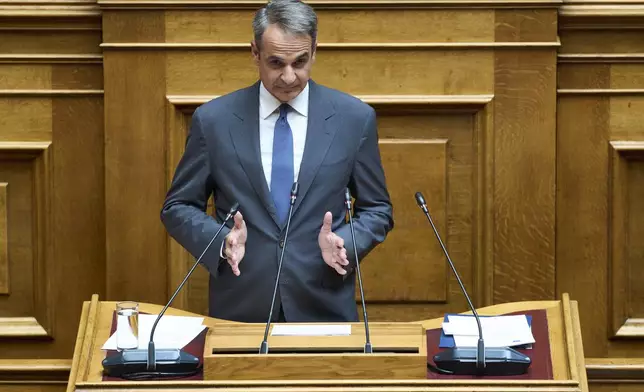 Greek Prime Minister Kyriakos Mitsotakis speaks during a parliamentary session on migration policy in Athens, Wednesday, July 9, 2025. (AP Photo/Petros Giannakouris)