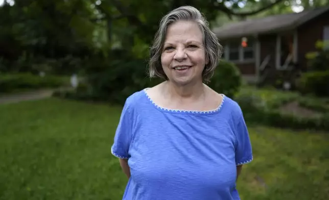 Carol Seegar, who has a deep brain stimulator, powered by an Abbott Brio IPG, implanted in her body, poses for a photo on Thursday, July 24, 2025, in Atlanta. (AP Photo/Mike Stewart)