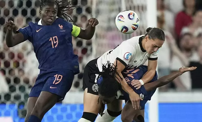 Germany's Giovanna Hoffmann, center, collides with France's Oriane Jean-Francois, right, and France's Griedge Mbock Bathy during the Women's Euro 2025 quarterfinals soccer match between France and Germany at St. Jakob-Park in Basel, Switzerland, Saturday, July 19, 2025. (AP Photo/Martin Meissner)