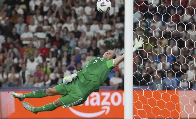 Germany goalkeeper Ann-Katrin Berger leaps to make a save during the Women's Euro 2025 quarterfinals soccer match between France and Germany at St. Jakob-Park in Basel, Switzerland, Saturday, July 19, 2025. (AP Photo/Martin Meissner)