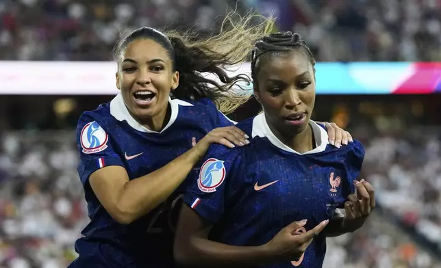 France's Grace Geyoro celebrates with Delphine Cascarino, left, after scoring the opening goal from the penalty spot during the Women's Euro 2025 quarterfinals soccer match between France and Germany at St. Jakob-Park in Basel, Switzerland, Saturday, July 19, 2025. (AP Photo/Alessandra Tarantino)